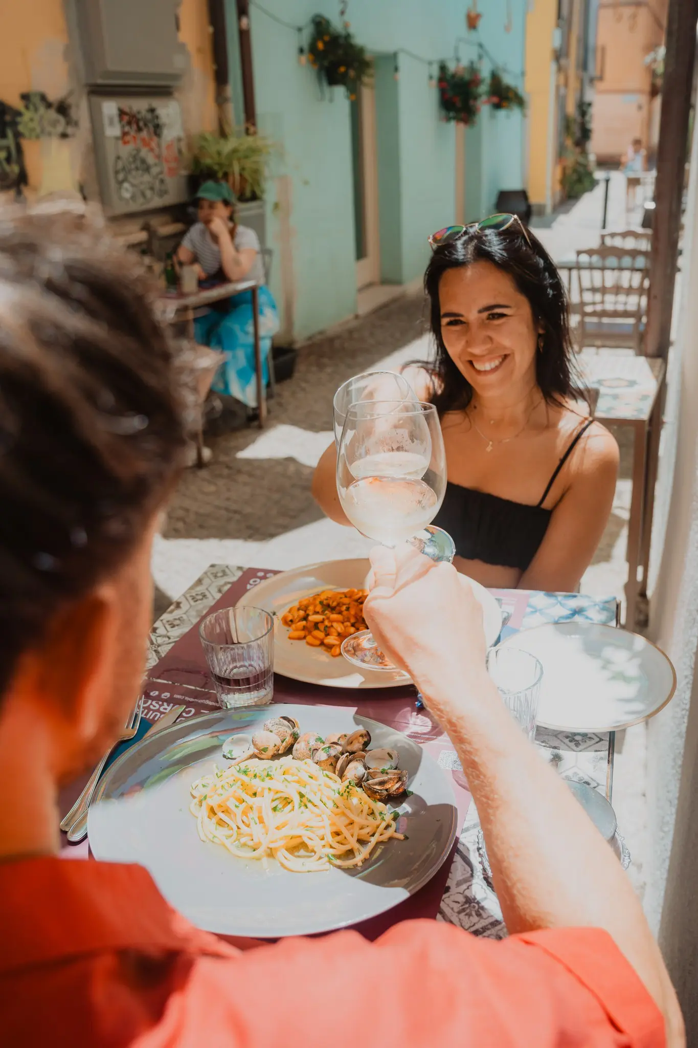 couple toasting with wine at an outdoor restaurant in Sardinia