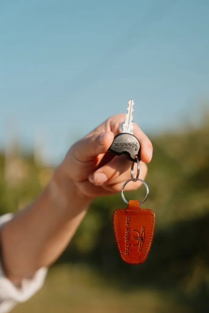 hand holding vespa key with leather keychain