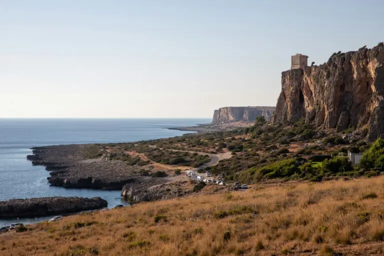 a rocky cliff overlooks a body of water