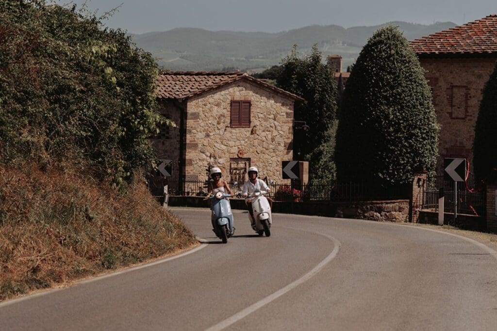 deux personnes sur deux vespa sur la route